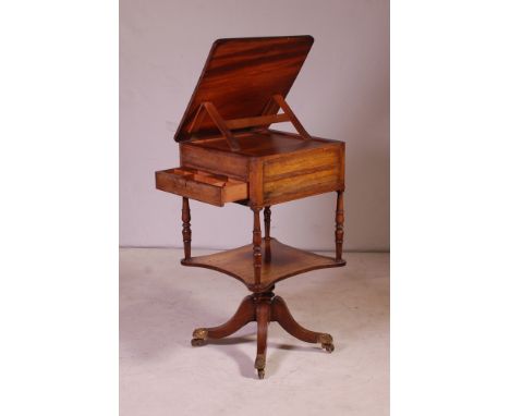 of small proportions, hinged adjustable top above single drawer on turned columns, single shelf above quadriform feet, having