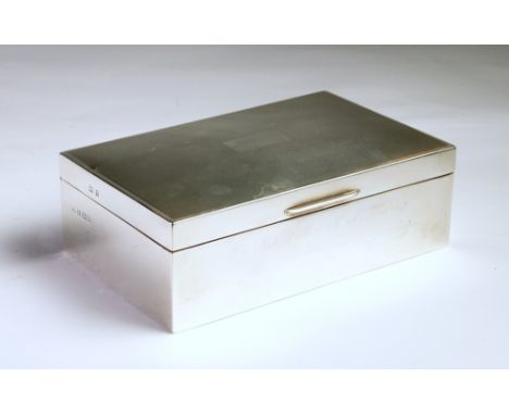the rectangular body engraved with an inscription, the hinged cover with engine-turned decoration centred with a cartouche wi