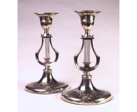 each oval gadrooned base, lyre harp-shaped column, urn-shaped sconce, detachable oval nozzle