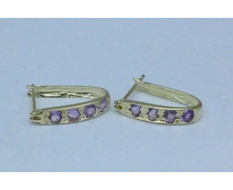 A pair of 9ct gold earrings set with amethyst