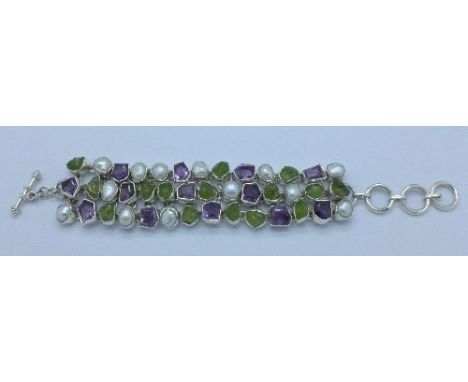 A silver amethyst, peridot and pearl bracelet