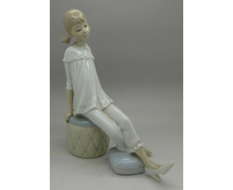 A Lladro figure, girl on a pouffe