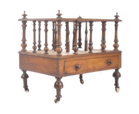 A Victorian 19th century walnut Canterbury magazine rack having finial top on a flat spindle gallery edge frame with three co