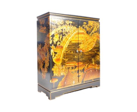 An early 20th century circa 1930s Chinese Oriental lacquered&nbsp; chinoiserie hand painted cupboard. The cabinet having a fl