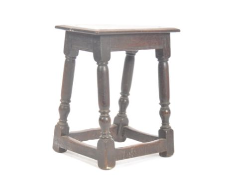 A 19th century carved oak joint stool. The stool of Jacobean 17th century influence being peg jointed with planked oak seat a