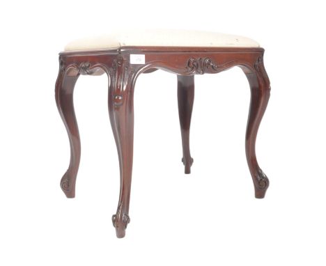 A Victorian 19th century mahogany cabriole leg dressing table stool. The stool of rectangular form having a padded upholstere