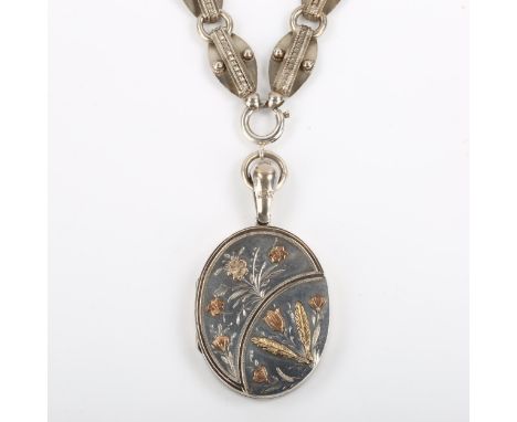 A Victorian Aesthetic Movement sterling silver photo locket pendant necklace, with applied gold floral decoration, on unmarke