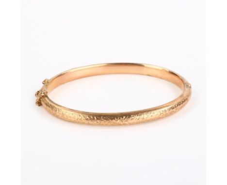 A Victorian 9ct rose gold floral hinged bangle, band width 5.3mm, internal measurements 5.5cm x 4.5cm, 7.5gNo damage or repai