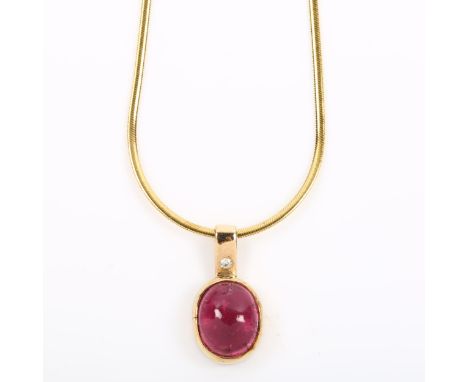 A modern cabochon ruby and diamond pendant necklace, on 9ct snake link chain, pendant height 18.4mm, chain length 40cm, 4.7gN
