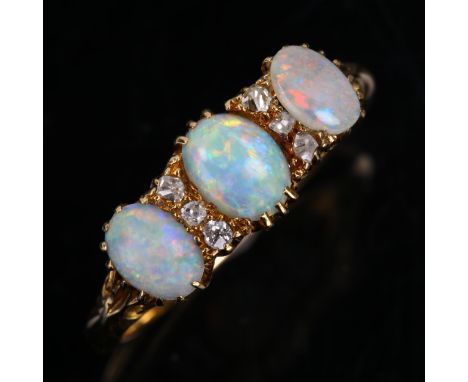 An early 20th century 18ct gold nine stone opal and diamond half hoop ring, set with oval cabochon opals and old-cut diamonds