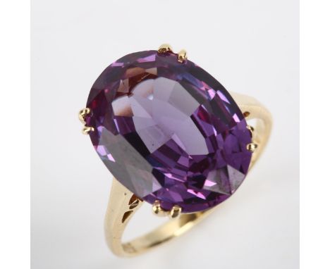 A modern 9ct gold synthetic sapphire dress ring, claw-set with oval mixed-cut sapphire, setting height 16mm, size M, 4.8gNo d