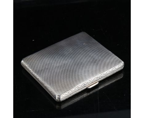 A George V square silver cigarette case, allover engine turned decoration with foliate border, by Cohen & Charles, hallmarks 