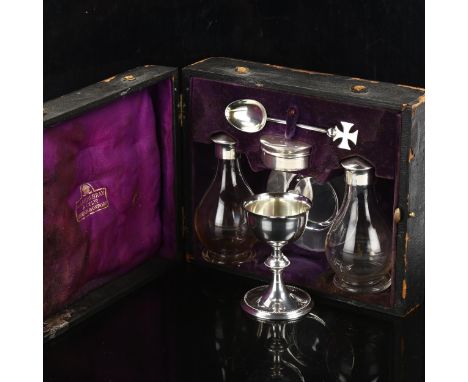 A leather-cased George V church communion set, comprising chalice, paten, wafer pyx, pair of glass cruets, and spoon, by A R 