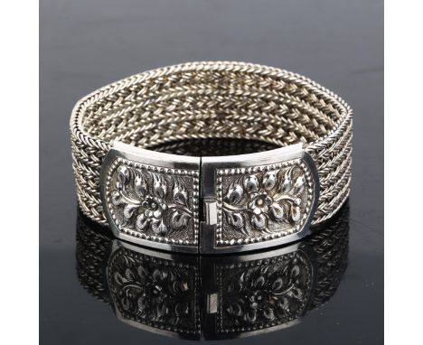 A heavy sterling silver basketweave link bracelet, with relief embossed floral clasp, bracelet length 20cm, 96.2gNo damage or