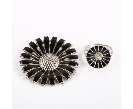 GEORG JENSEN - a Danish sterling silver and black enamel daisy pattern matching ring and pendant/brooch, ring setting height 