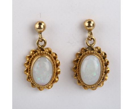A pair of 9ct gold opal drop earrings, set with oval cabochon white opal within twist surround and stud fittings, earring hei