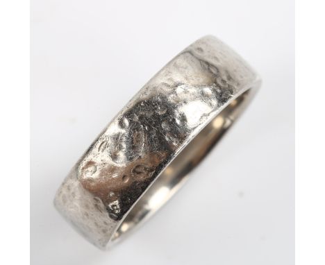 A palladium wedding band ring, by Brag, textured decoration, band width 6.8mm, size U, 9.4gNo damage or repairs, only light s