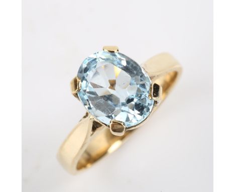 A modern blue topaz dress ring, unmarked gold settings with oval mixed-cut topaz, setting height 10.2mm, size M, 3.3gNo damag