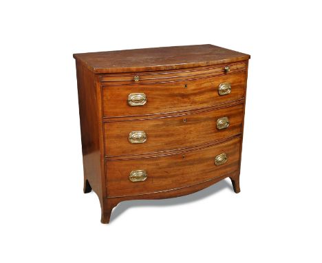 A Regency mahogany bow front chest with brushing slide, the baize lined slide above three long drawers with later brass handl