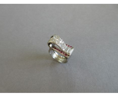 An asymmetrical diamond and synthetic ruby ring, designed as a raised scroll set with single cut diamonds with two baguette d