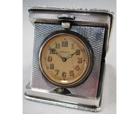 A George V silver folding travel clock, William Base & Sons, Birmingham 1927, engine turned rounded rectangular covers, 'RH' 