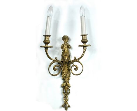 A pair of ormolu two-light wall sconces, each surmounted with a putto playing pipes above acanthus and foliate scroll work 47