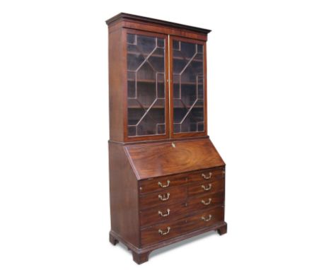 A George III mahogany bureau bookcase, with dentil moulded cornice, astragal glazed doors above a bureau with fitted interior
