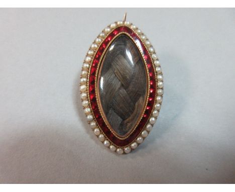 A Georgian memento brooch, of navette form with a central glazed panel containing carefully plaited chestnut hair within a do