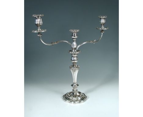 An old Sheffield plate three light, two branch candelabra, with scrolling acanthus cast arms and campana sockets, the baluste