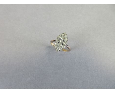 A navette form diamond cluster ring, the shaped plaque close set with fifteen old round, oval and cushion cut diamonds, to bi