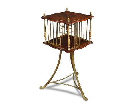 An Edwardian mahogany revolving bookstand, with gilt brass divisions, columns and finials, on three brass swept legs, stamped