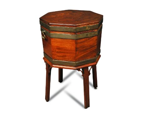 A George III octagonal mahogany and brass bound wine cooler, with brass side carrying handles, a divided lead lined interior,