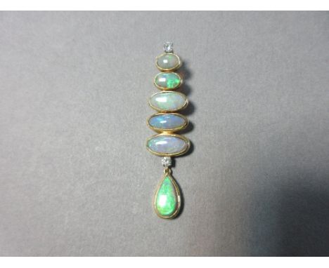 An opal and diamond pendant by Andrew Grima, designed as a vertical line of horizontal graduated oval opal cabochons, collet 