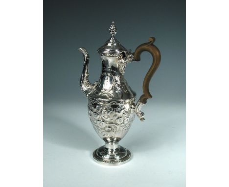A George III silver coffee pot, Sheffield 1777, the baluster body later embossed with foliage and scrollwork, the double dome