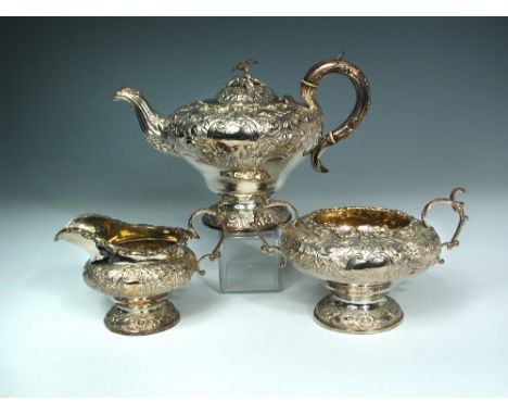 A William IV silver three piece tea service, probably by J. Whitehouse, London 1832, the ogee pedestal bodies elaborately emb