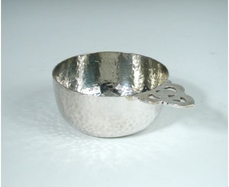 An Edwardian silver porringer, by Millar Wilkinson, London 1904, with hammered finish and pierced handle, 7.5oz 15cm (6in)  