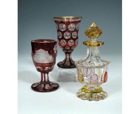 A 19th century Bohemian ruby overlay glass goblet, the body inscribed 'Hoftheater in Dresden', 13cm (5.1in) high; another, th