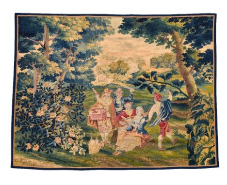 A late 17th or early 18th century Flemish tapestry hanging, depicting a picnic party within a landscape, modern yellow border