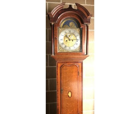 An oak chiming longcase clock, the 12inch brass dial with moonphase disc to the arch, urn spandrels, silvered chapter ring an