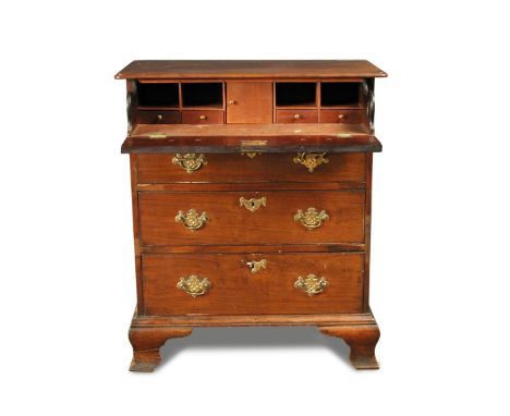 A small George III mahogany chest of four long drawers, with fitted secretaire drawer, cut brass plate handles, on ogee brack