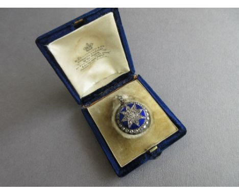 A 19th century diamond and blue enamel locket in fitted Garrard case, the circular blue guilloche enamel face filled with an 