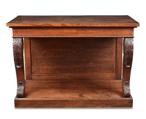 A Regency oak console, on leaf carved scroll bracket supports and plinth base 85 x 125 x 62cm (33 x 49 x 24in)  There is slig