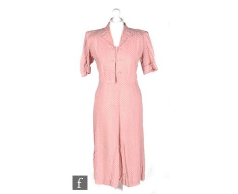 A 1940s ladies CC41 Utility vintage dress in pink heavy crepe with white polka dot pattern, with collar and double-breasted b