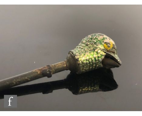An early 20th Century model of the head of a bird with remains of green and yellow enamel decoration, length 4cm, possibly a 