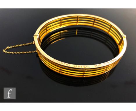An early 20th Century 9ct rose gold, five bar hinged bangle, weight 17g, terminating in tongue and box fastener, presentation