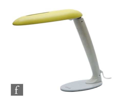 A vintage 1980s Philips adjustable desk/table lamp, the white oval base to a angular stem with adjustable yellow shade, with 