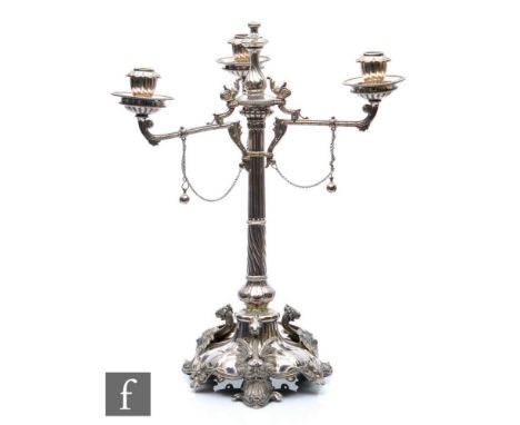 A late 19th Century silver plated three light candelabra with three griffins to tri-form shaped base, rising to part wrythen 