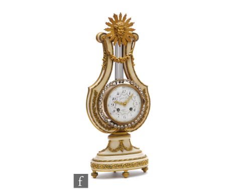 A late 19th Century French lyre shaped Marie Antoinette mantel clock with eight-day movement striking on a bell, the gilt met