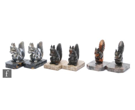 A pair of 20th Century Art Deco chromed spelter bookends modelled as stylised squirrels mounted to veined marble bases, heigh