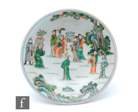 A Chinese porcelain famille verte stem cup, the splayed base extending to a circular shallow upper dish, painted with officia